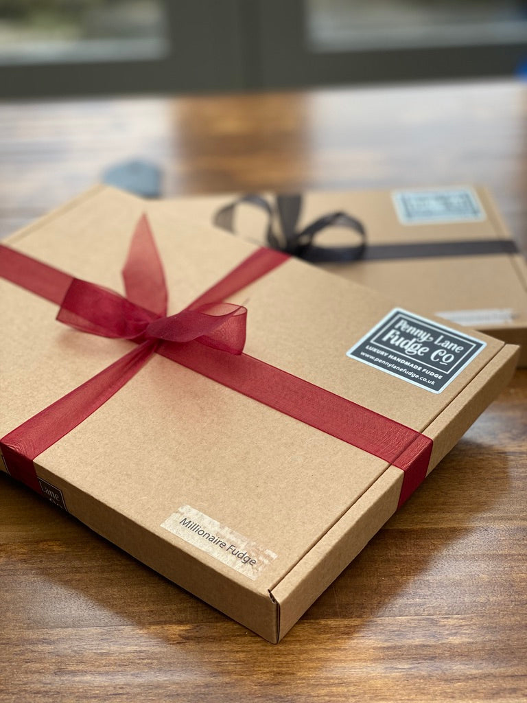 Gift box with a red ribbon on a wooden surface