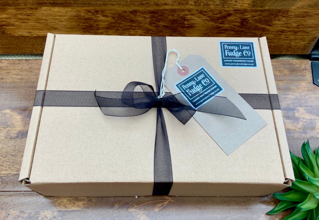 Gift box with a black ribbon and tag on a wooden surface