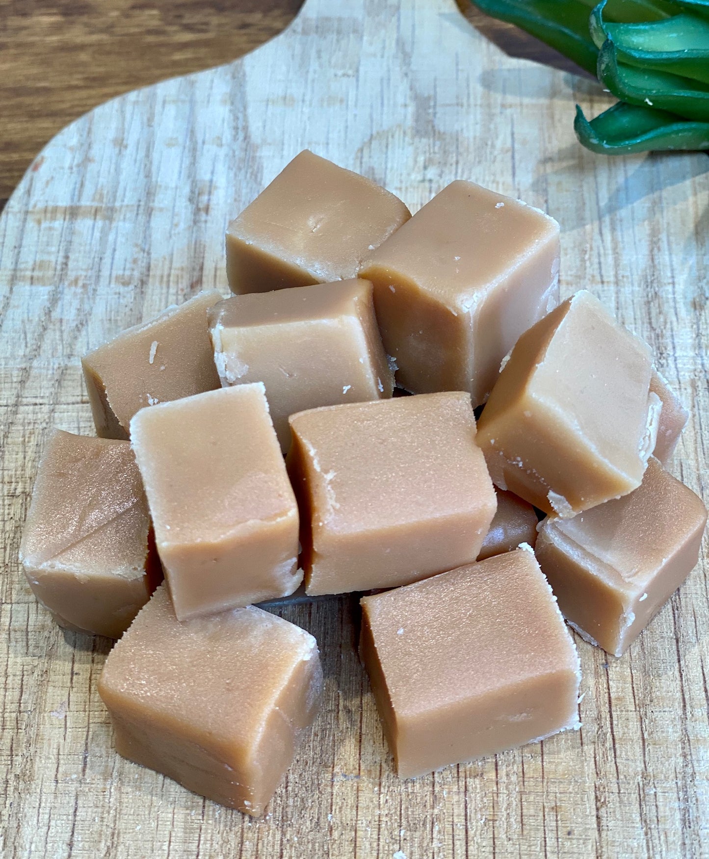 Cubes of creamy fudge on a wooden surface