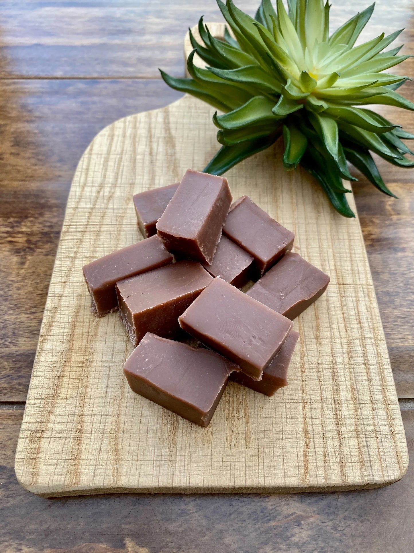 Handmade sea salt caramel fudge cubed on wooden board