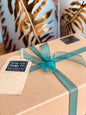 Gift box with green ribbon and a tag on a decorative background