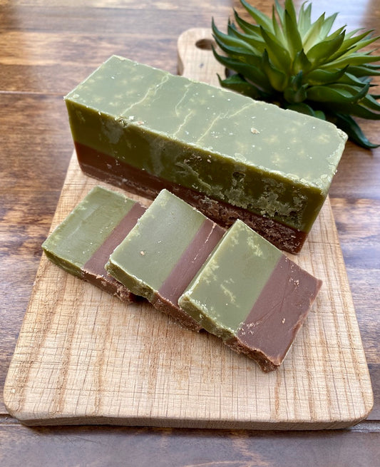 Mint chocolate fudge slices stacked on a wooden chopping board – cool and indulgent treat