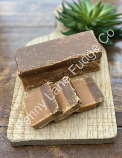 caramel Fudge bars on a wooden board with 'Penny Lane Fudge Co' branding.