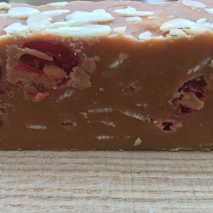 Close-up of a block of cherry and almond fudge with 'Penny Lane Fudge Co' branding.
