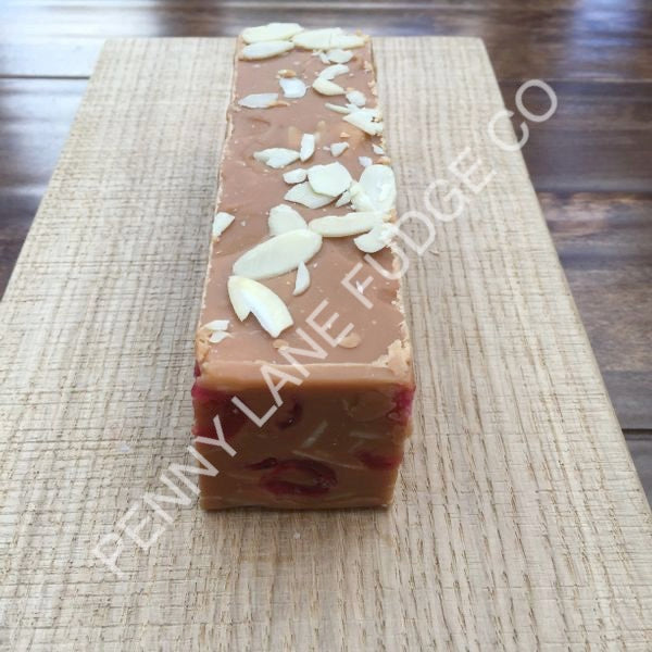 Close-up of a block of cherry and almond fudge with 'Penny Lane Fudge Co' branding.