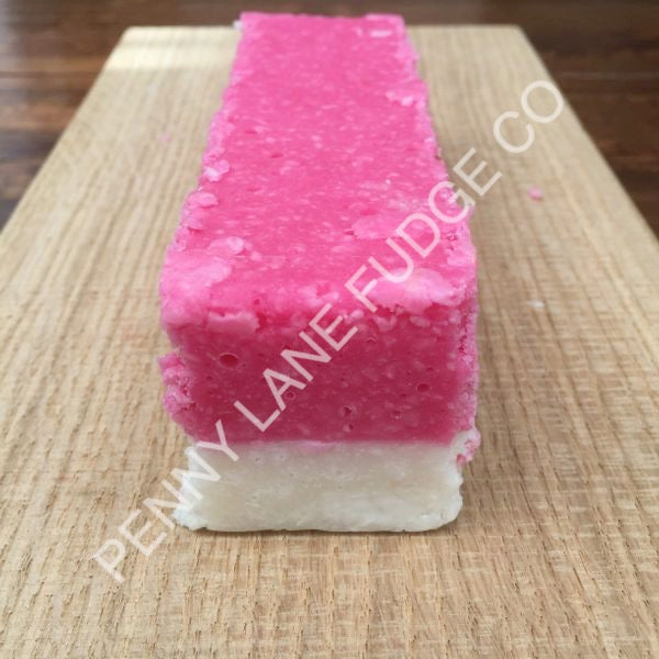 Pink and white layered coconut ice with 'Penny Lane Fudge Co' branding on a wooden surface