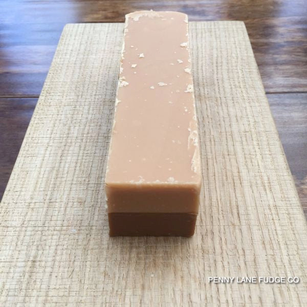 Bar of coffee and cream fudge on a textured surface with 'Penny Lane Fudge Co' branding.