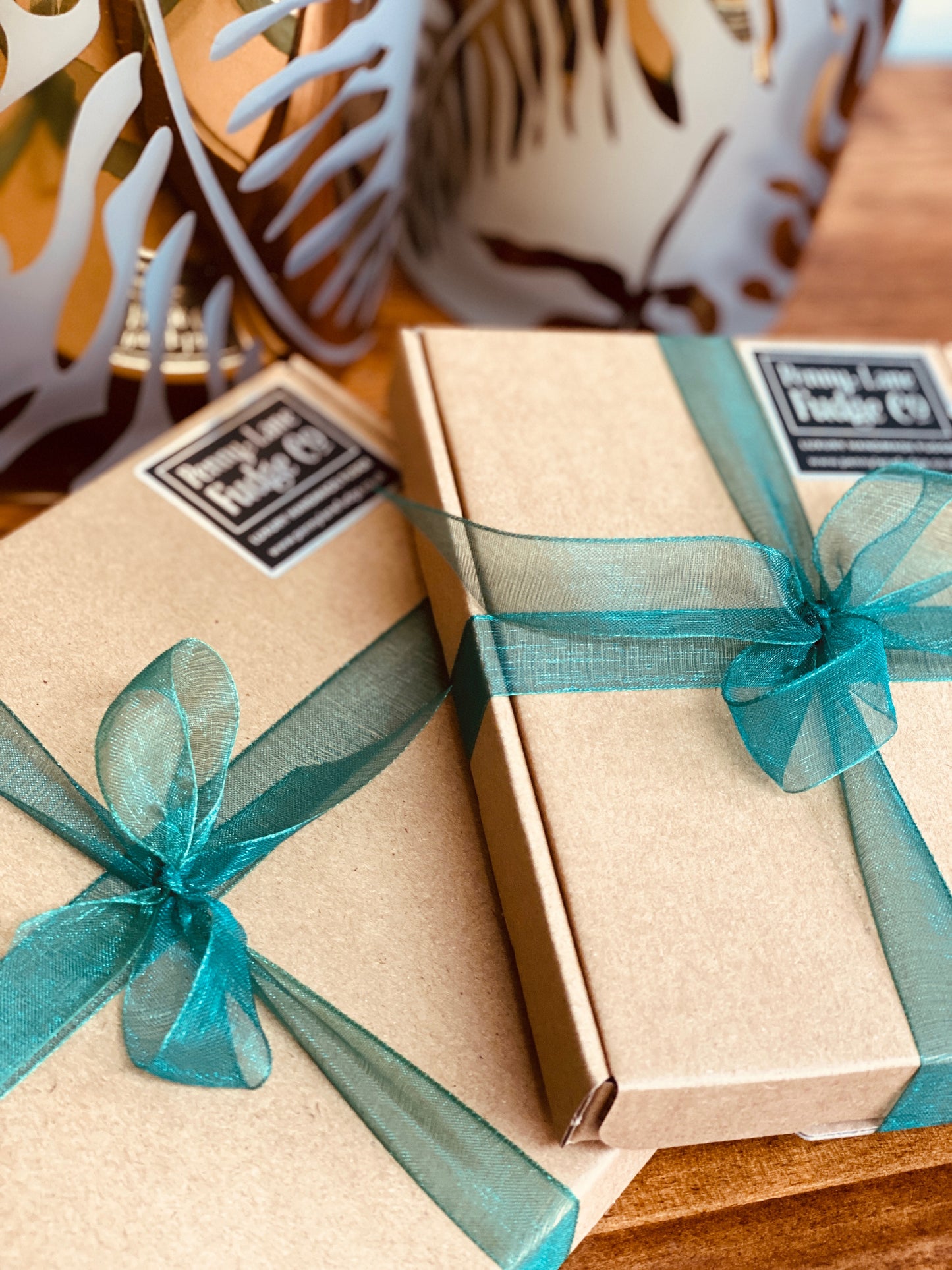 Medium gift-wrapped box containing two handcrafted fudge flavours, neatly presented woth green ribbon.