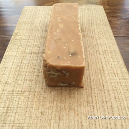 Close-up of a block of maple and walnut fudge with 'Penny Lane Fudge Co' branding.