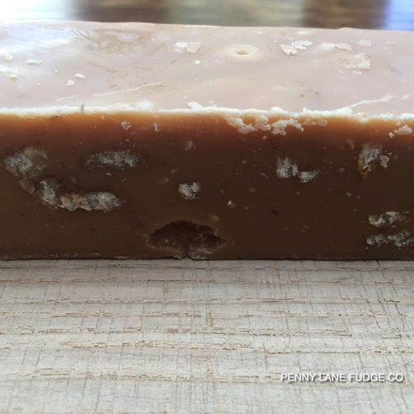 Close-up of a block of maple and walnut fudge with 'Penny Lane Fudge Co' branding.