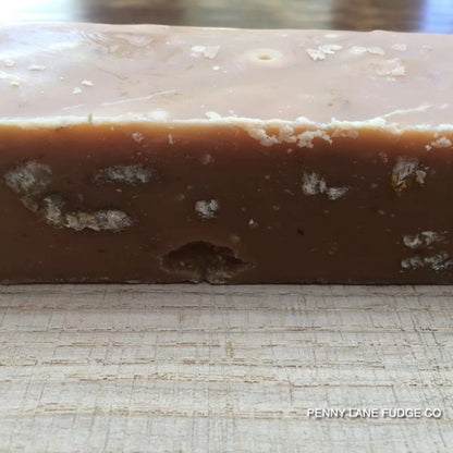 Close-up of a block of maple and walnut fudge with 'Penny Lane Fudge Co' branding.