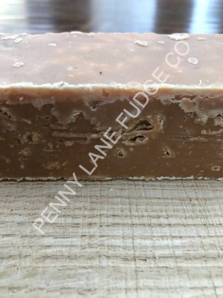 Bar of stem ginger fudge with 'Penny Lane Fudge Co' branding on a textured surface.