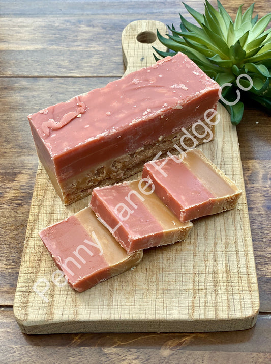 strawberry and cream Fudge bar on a wooden cutting board with 'Penny Lane Fudge Co' branding.