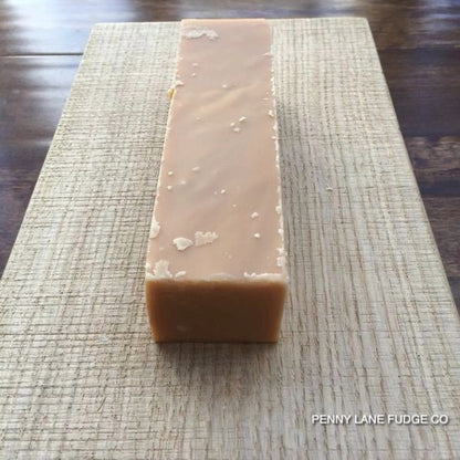 creamy fudge bar on a textured surface with 'Penny Lane Fudge Co' branding.