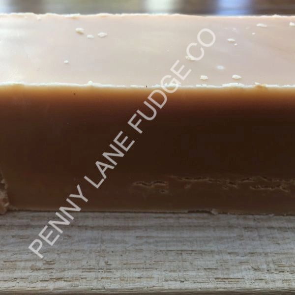 close up of peanut butter fudge with 'Penny Lane Fudge Co' branding on a wooden surface.